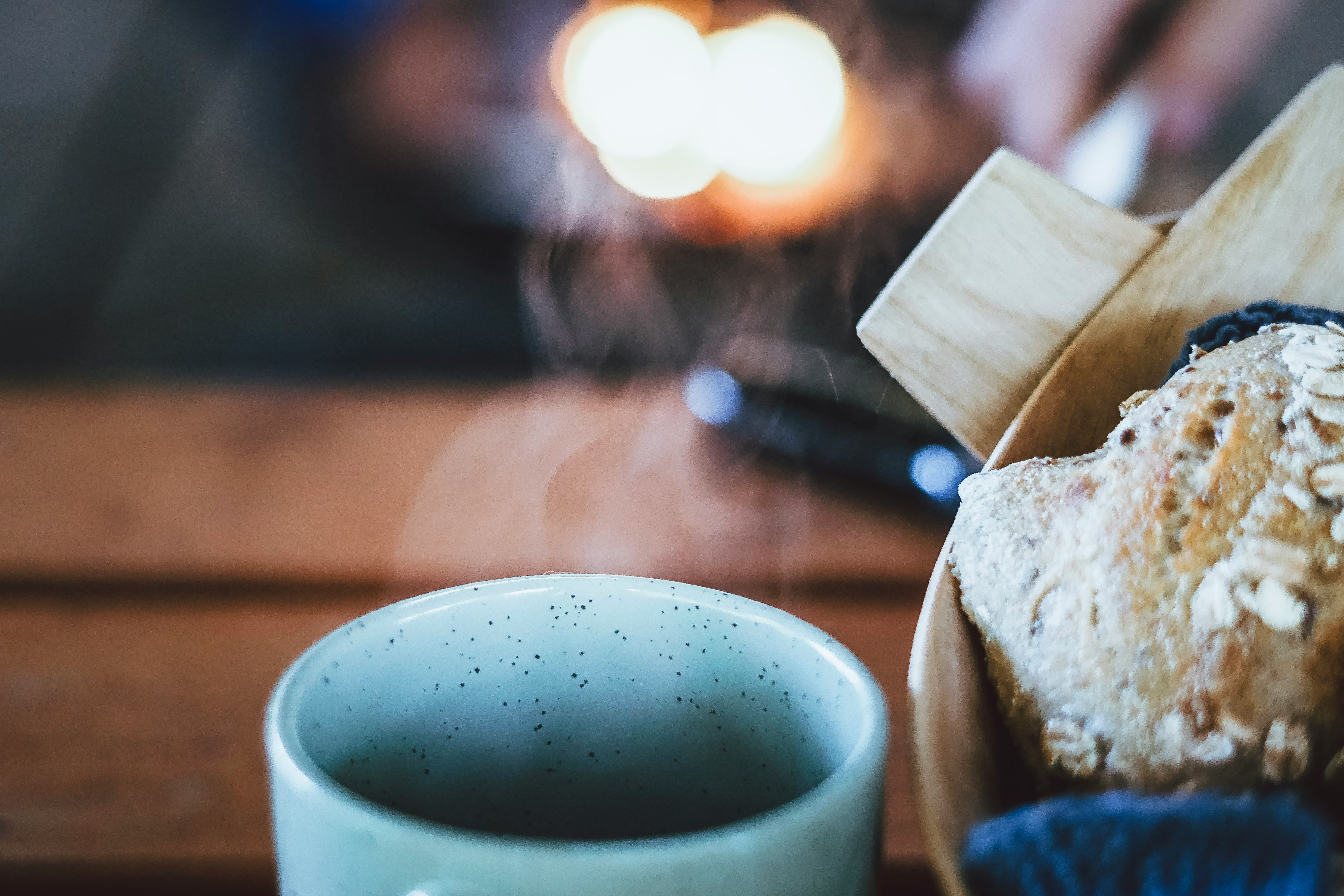 white ceramic mug beside bread